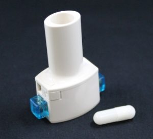 Dry Powder Inhaler (DPI) device alongside a capsule which can be filled with spray dried powder as an inhaled formulation for pulmonary delivery